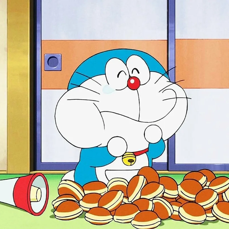 Dễ thương quá mức với hình doraemon ăn bánh rán